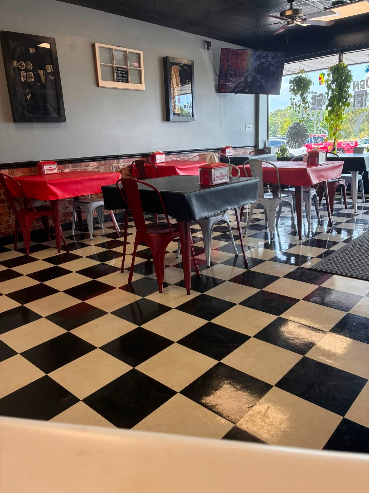 Inside: red tables and a black and white checkerboard floor