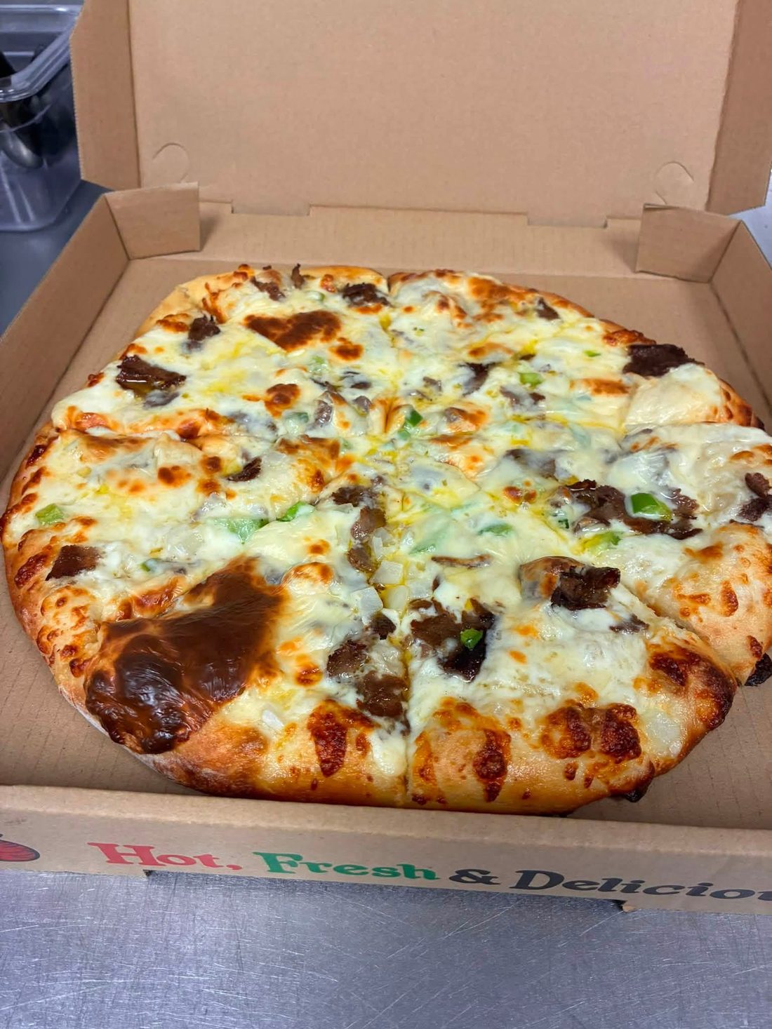 Pizza with steak, peppers and cheese