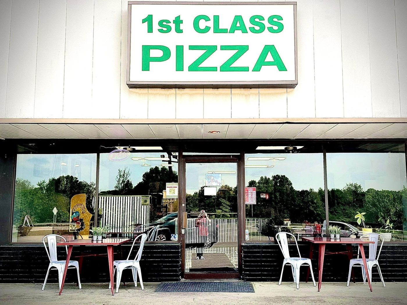 The 1st Class Pizza storefront with tables out front